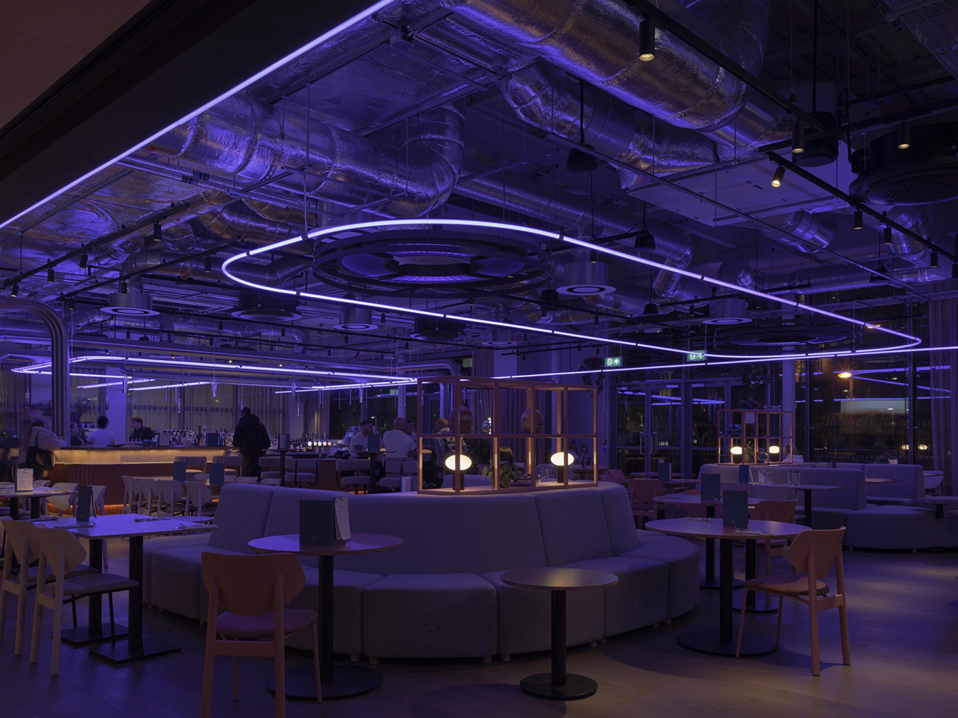 Contemporary interior of Junction at Manchester Central featuring stylish seating and vibrant purple lighting for a unique atmosphere.