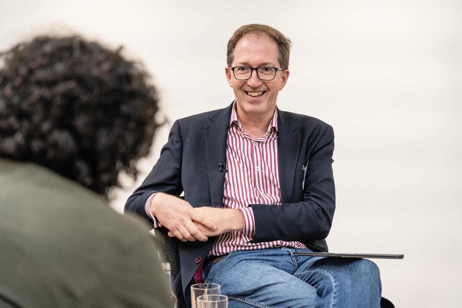 Discussion at the Material Source Studio Presents seminar on Glasgow property outlook, featuring an engaged speaker and audience member.