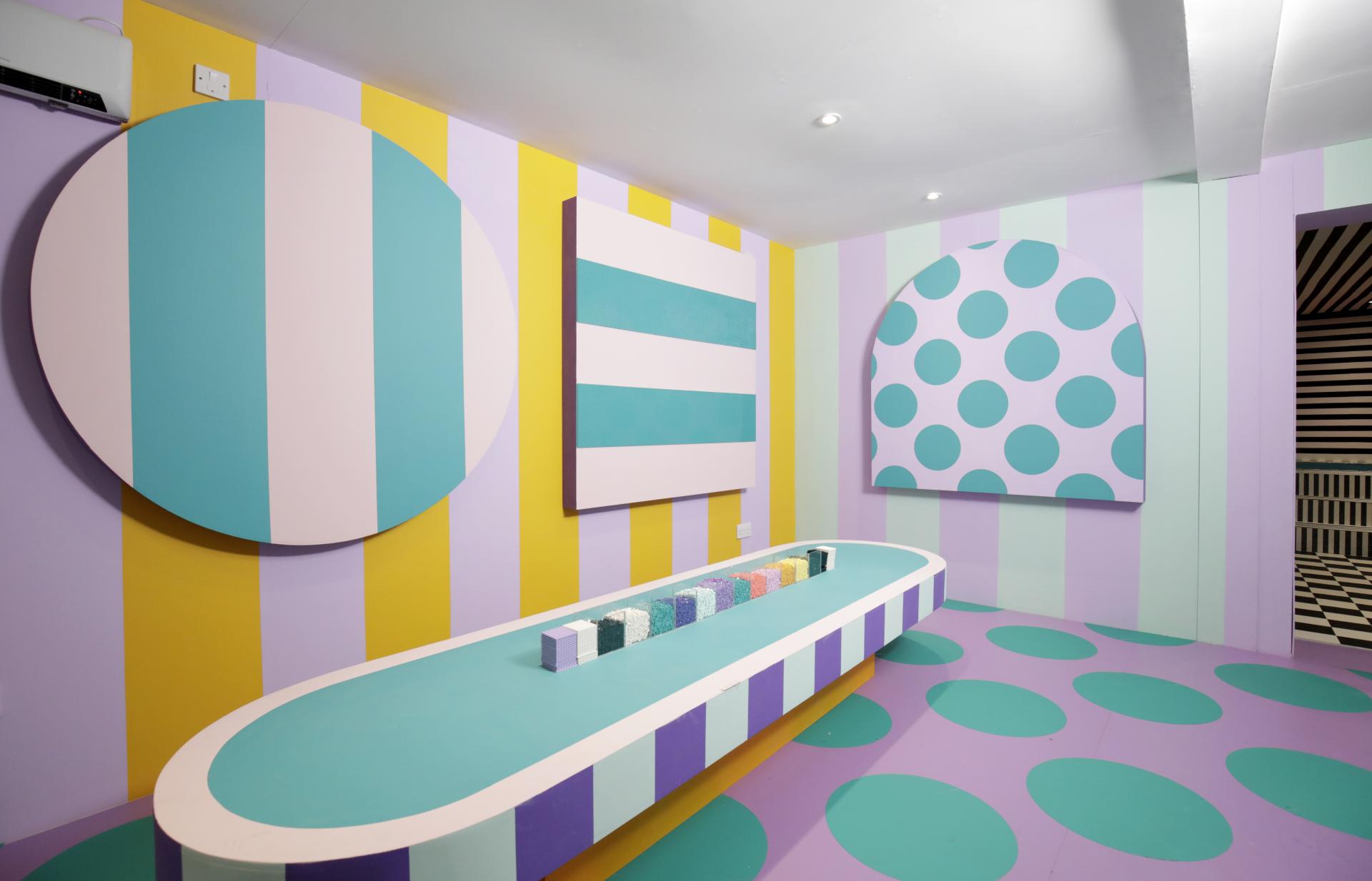 Colorful interior of Camille Walala's HOUSE OF DOTS, featuring playful patterns and interactive elements in London.