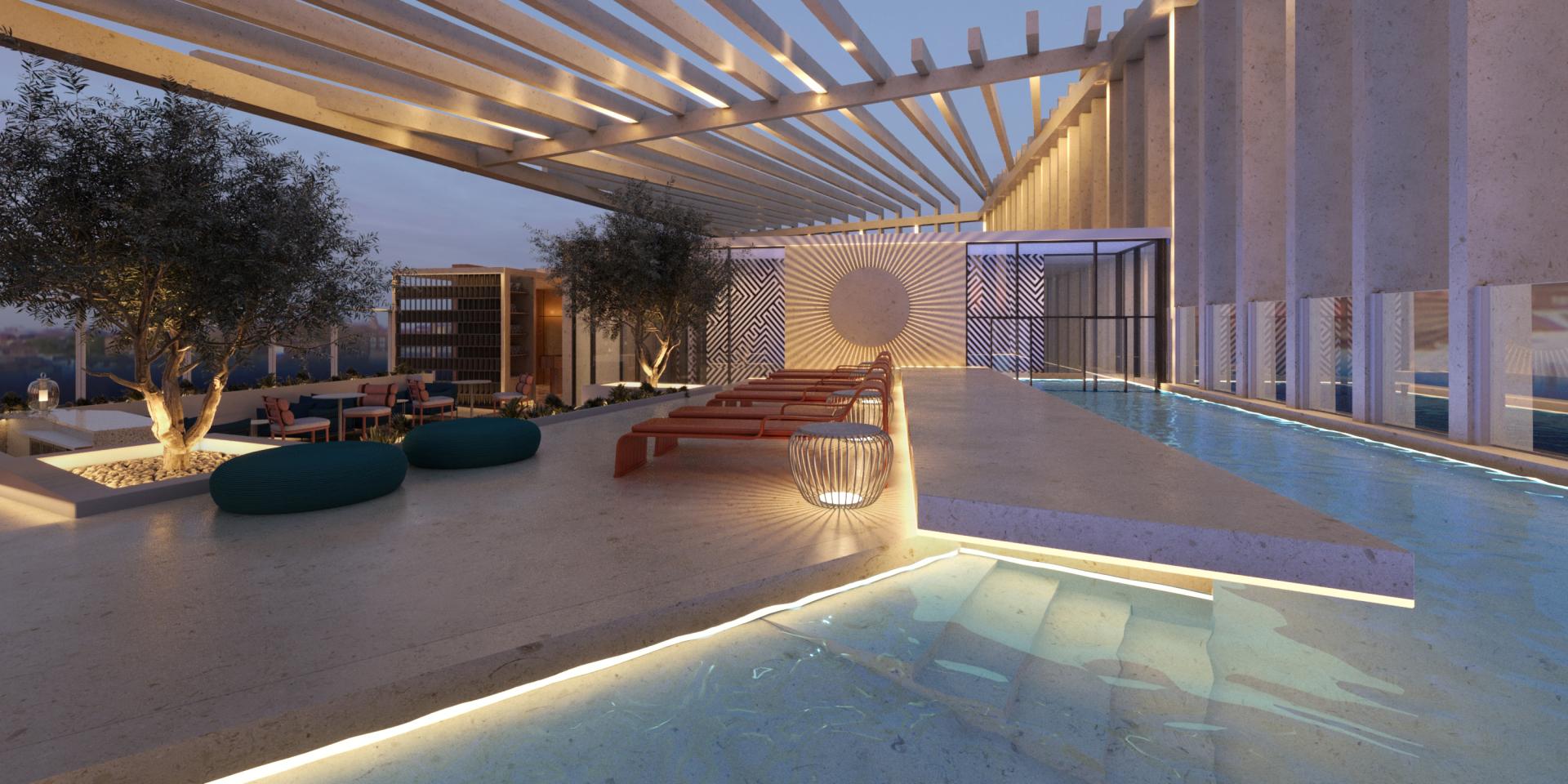 Modern outdoor terrace of Tribe hotel in Malta featuring a pool, seating areas, and stylish landscaping.