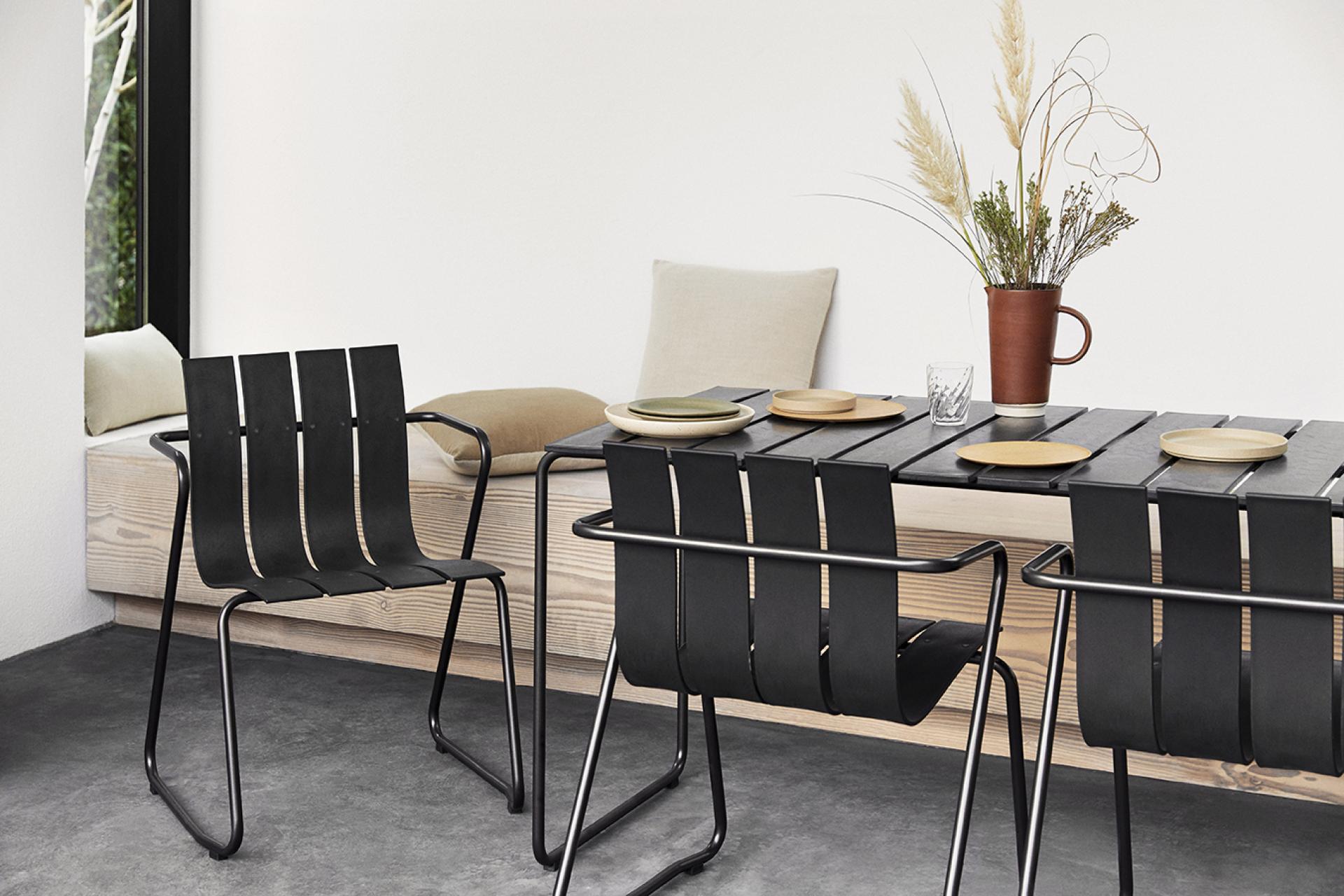 Elegant dining setup featuring the Ocean Collection chairs and table by Mater, showcasing sustainable Danish design.