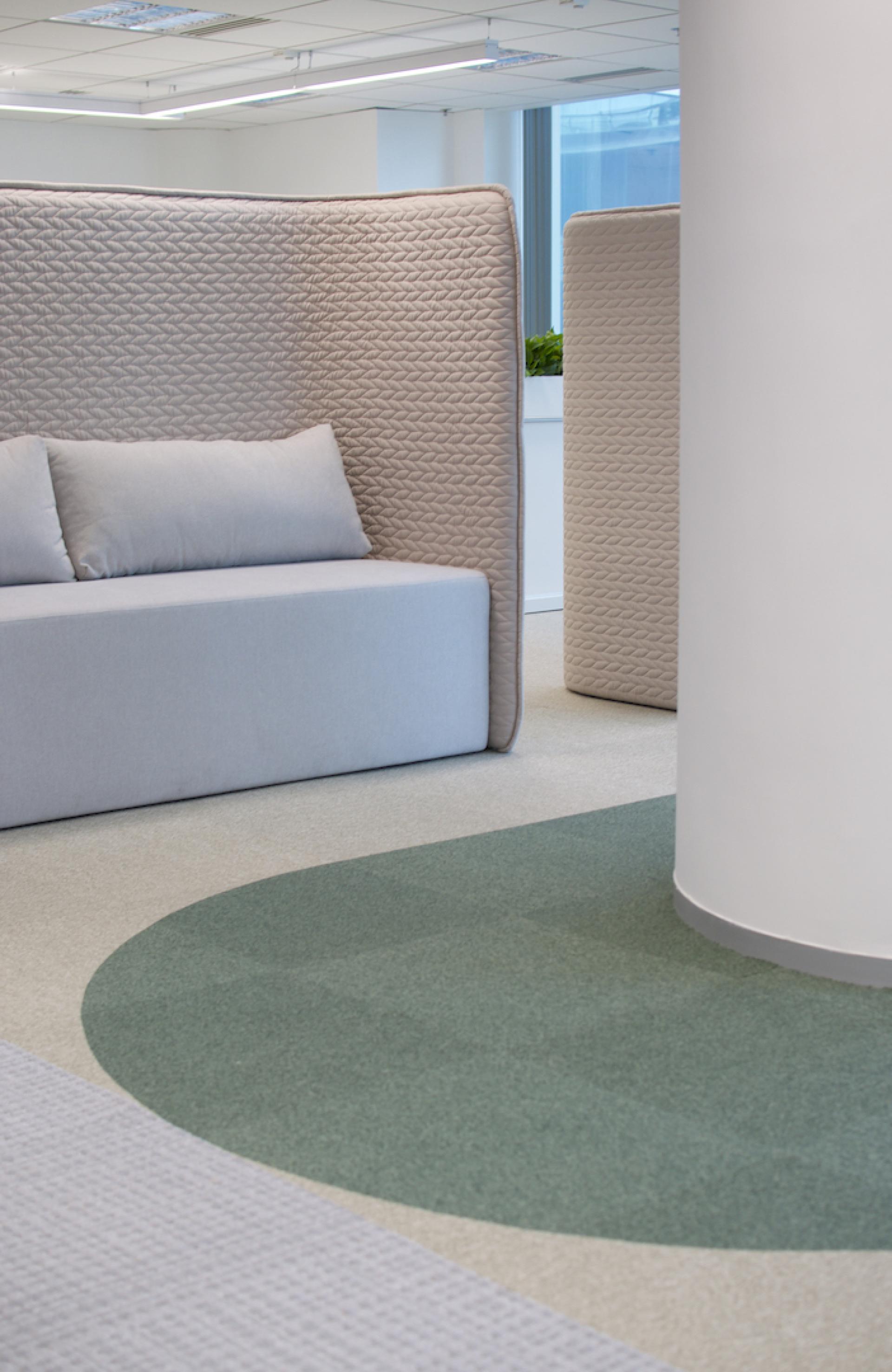 Modern agile workspace design featuring cozy seating and partitions for Jardine Restaurant Group by Bean Buro.