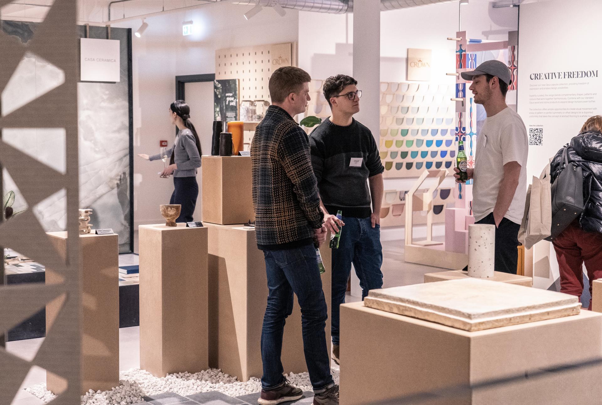 Attendees engage in discussions about innovative design and technology at the Material Source Studio event.