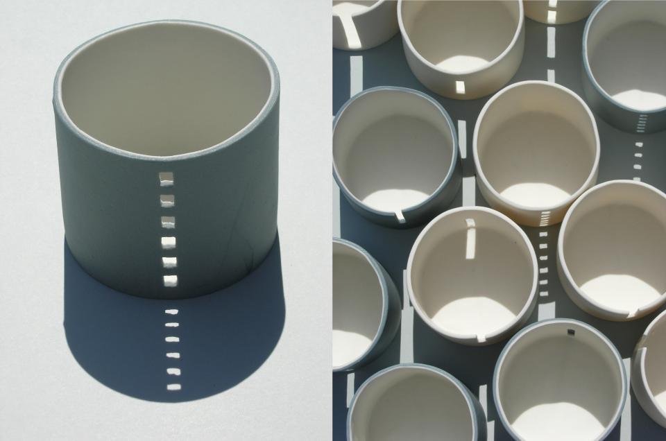 Ceramic vessels by Jo Woffinden casting intricate shadows, showcasing contemporary craft at the Harewood House Biennial.