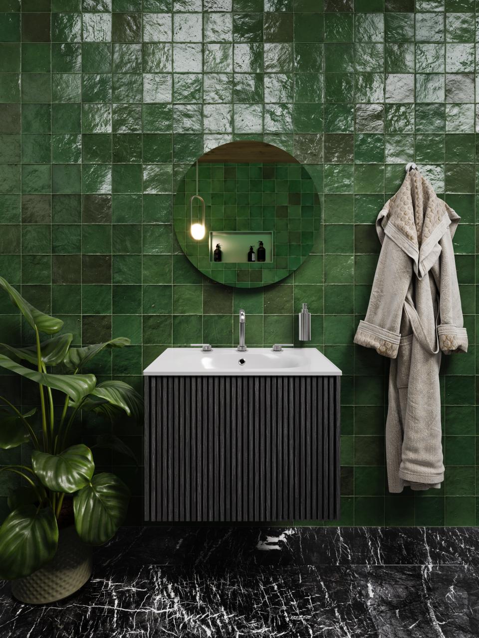 Stylish bathroom featuring green tiled walls, modern vanity, round mirror, and plant, showcasing playful nostalgia and Japanese Nouveau aesthetics.