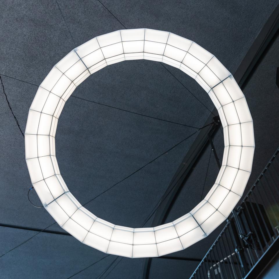 Dramatic circular light installation by Studio Mieke Meijer illuminating the interior of Coal Drops Yard.