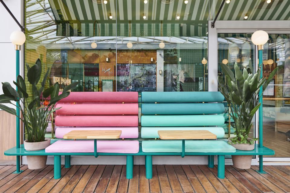 Contemporary seating area featuring colorful cushions and plants, showcasing Masquespacio's design for Piada in Lyon.