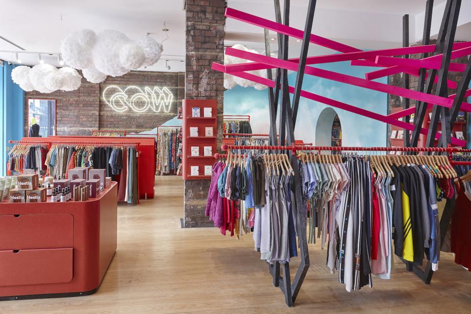 Colorful vintage clothing racks and vibrant displays inside COW's new flagship store in Leeds, showcasing a trendy shopping environment.