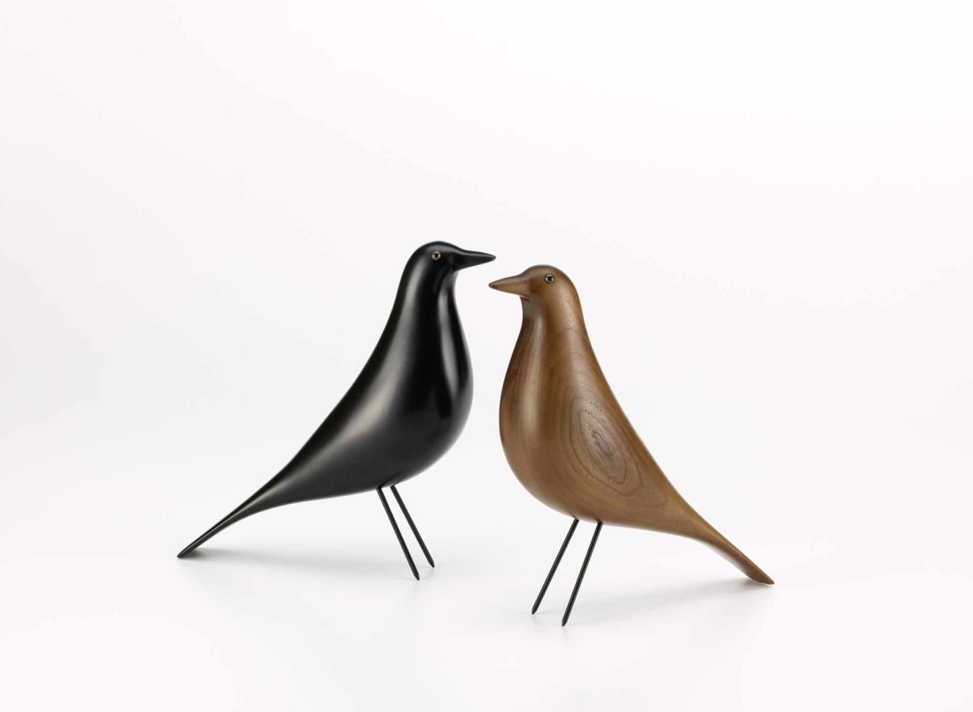 Wooden bird figurines by Charles and Ray Eames, showcasing sleek designs in black and brown, part of Vitra’s Accessories Collection.