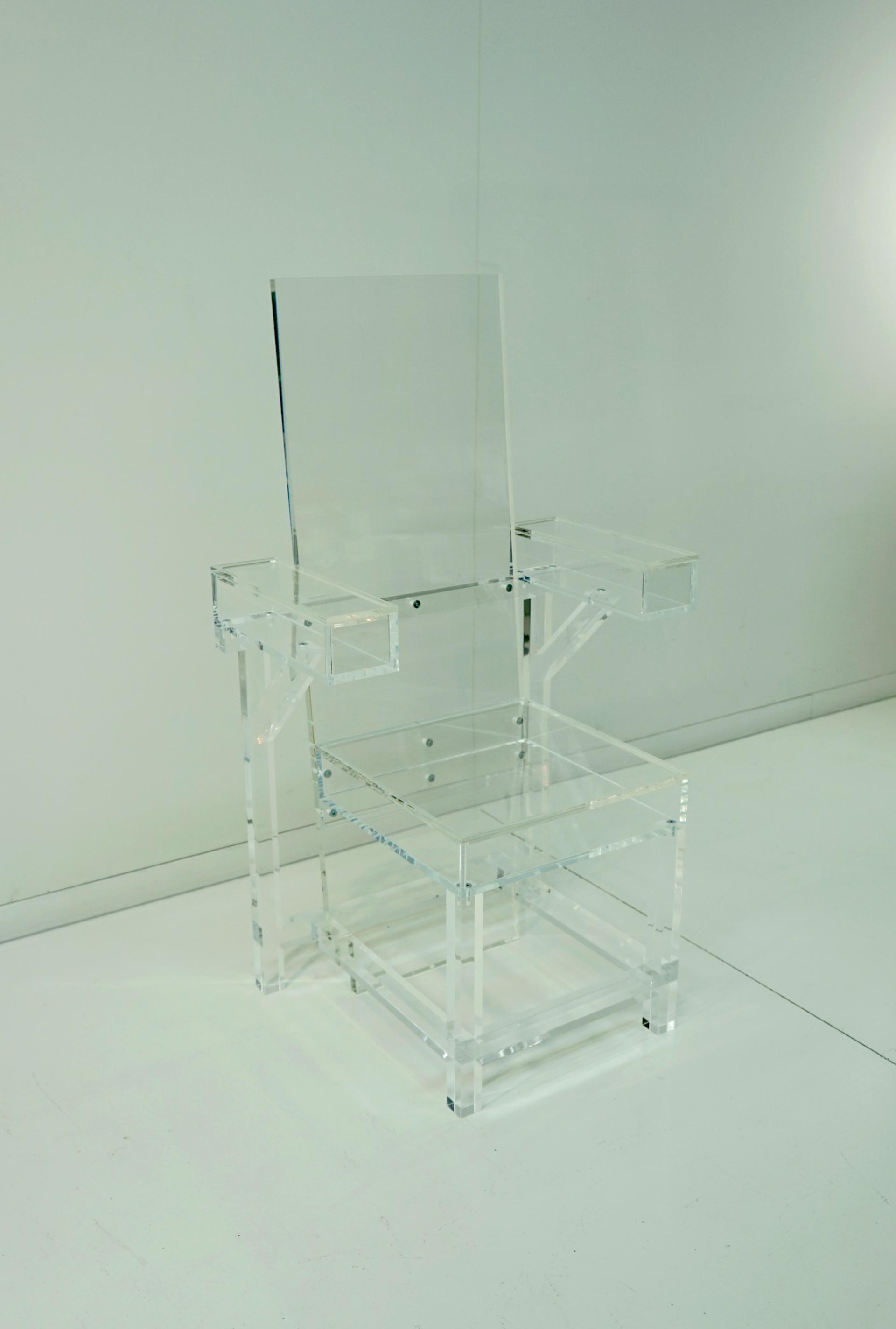 Transparent acrylic chair on a minimalist background, showcasing modern design principles in Ruud van Eijk's work.