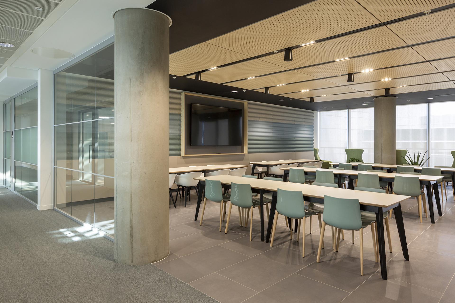 Modern office space featuring tables and chairs, emphasizing design trends and collaborative work environments for the future.