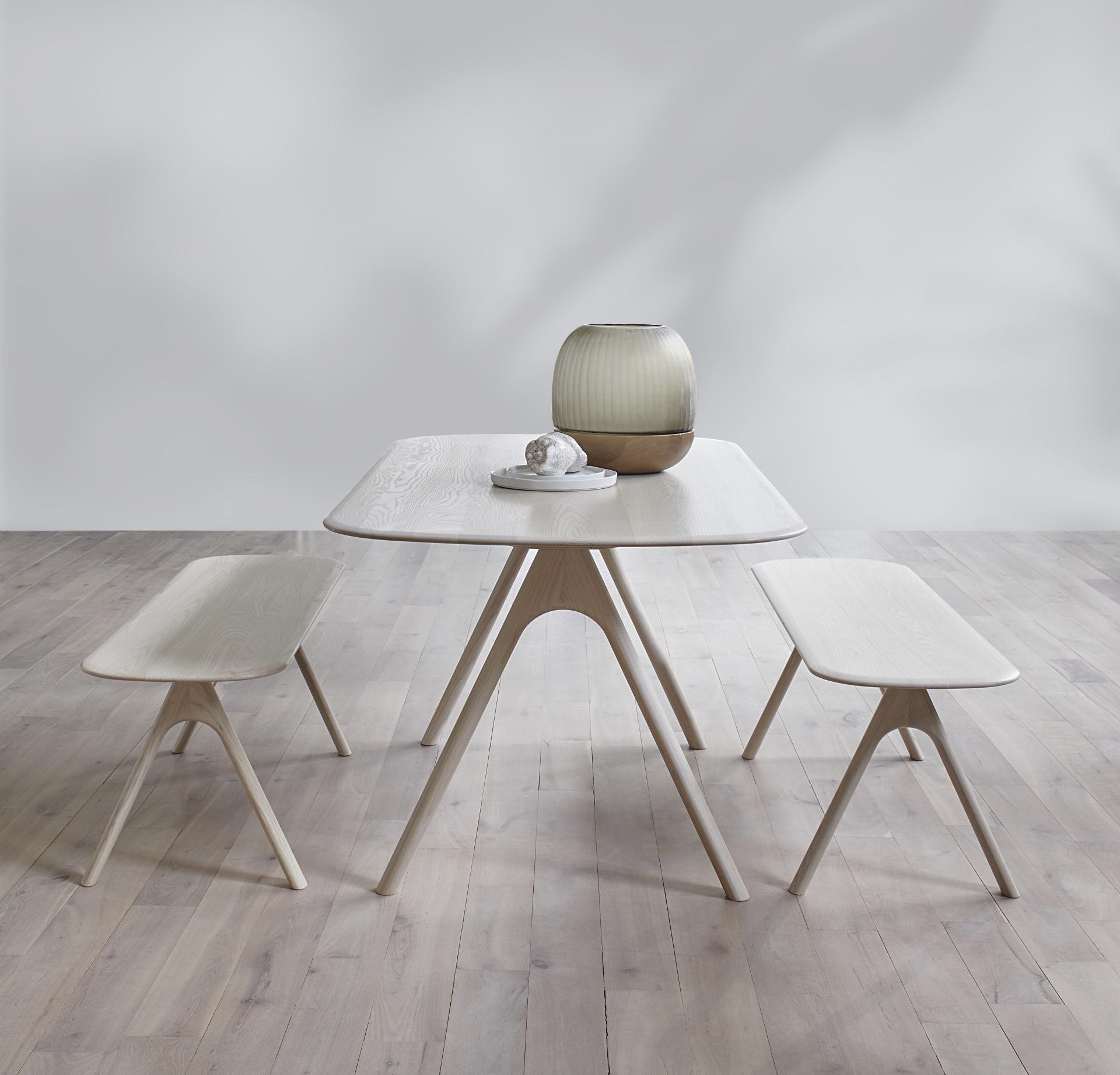 Modern wooden table and benches with a decorative lamp, showcased for the Wood Awards 2021 nominations.