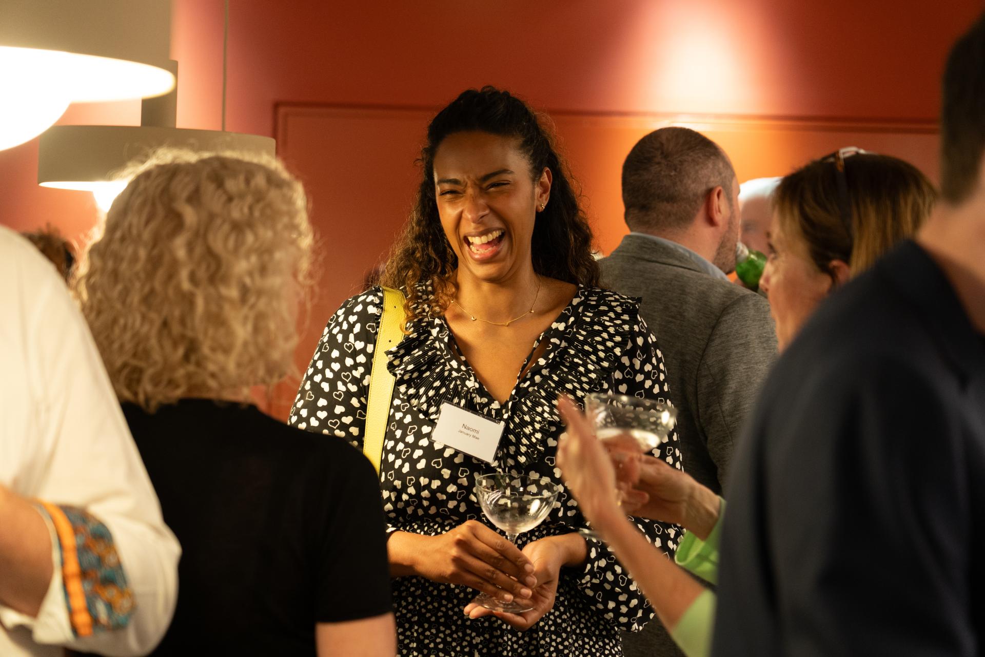 Networking event in Glasgow, featuring attendees engaging and smiling, highlighting a positive property outlook.