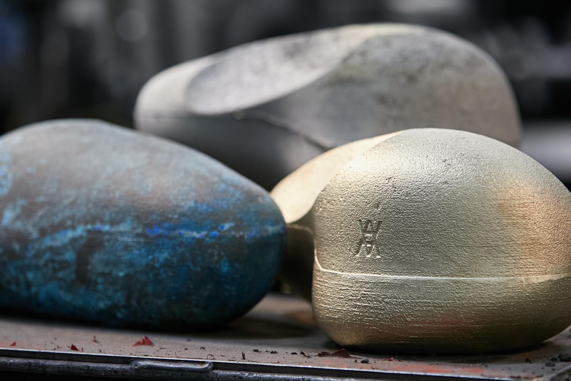 Three artistic 3D-printed sink prototypes in blue and gold, created as part of the Kohler x Daniel Arsham collaboration.