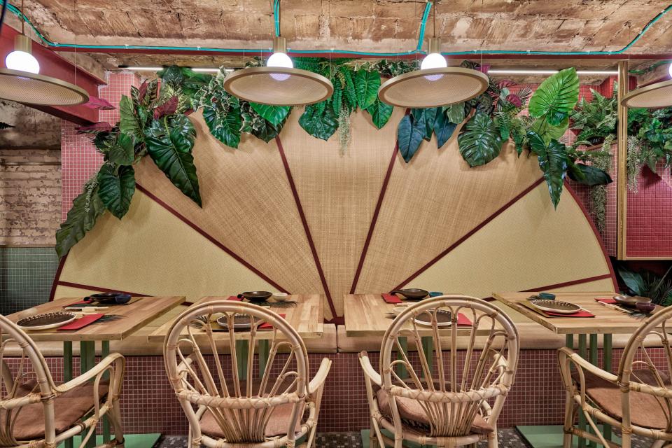 Lush tropical interior of Kaikaya, featuring natural elements, modern furniture, and a vibrant atmosphere for sushi dining.