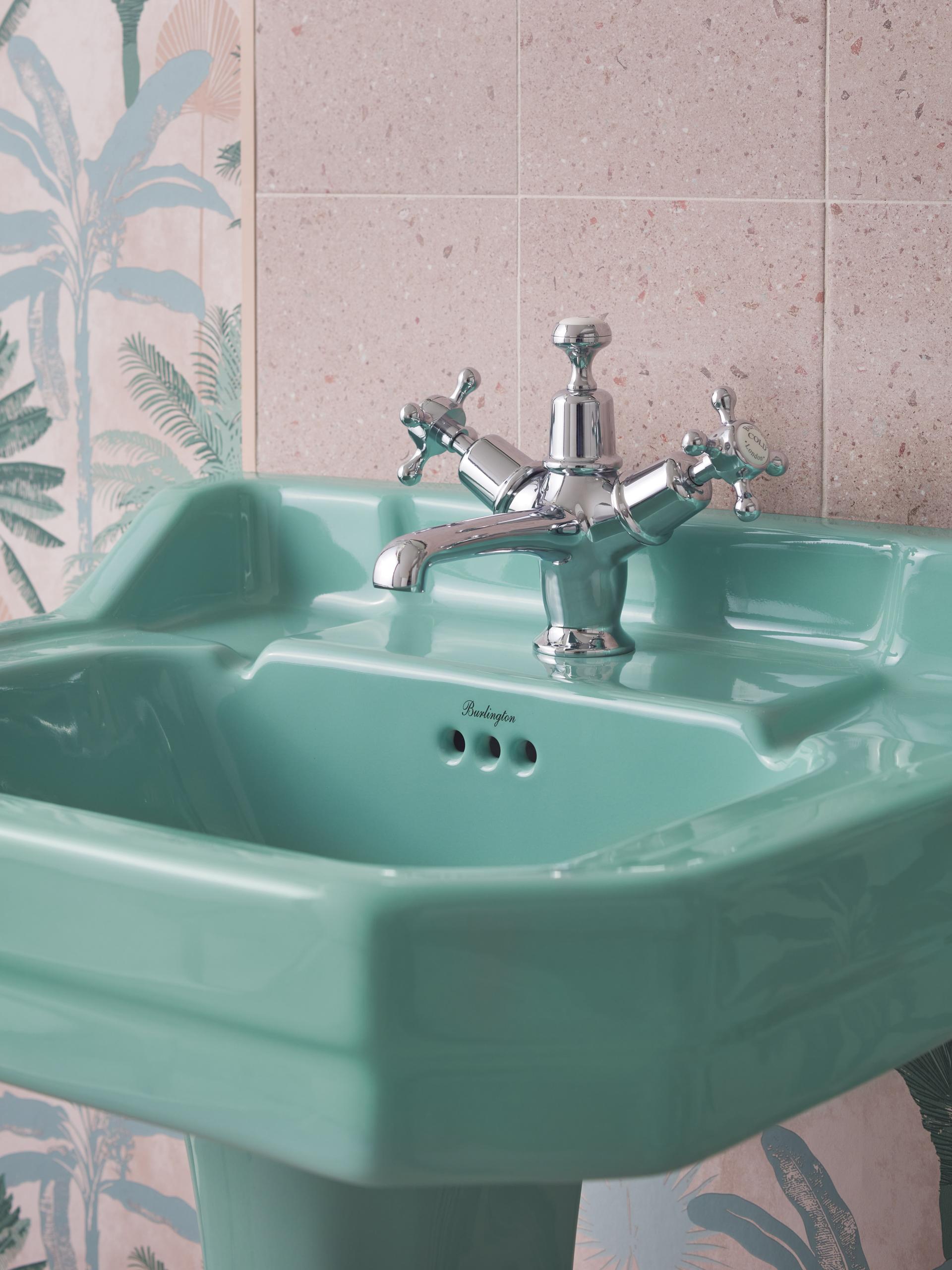 Burlington ceramic sink in Cosmic Green, featuring a stylish chrome faucet and decorative floral wall tiles.