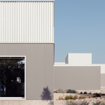 Modern architecture featuring ceramic cladding, showcasing innovative design and creative use of tiles in a landscaped exterior.
