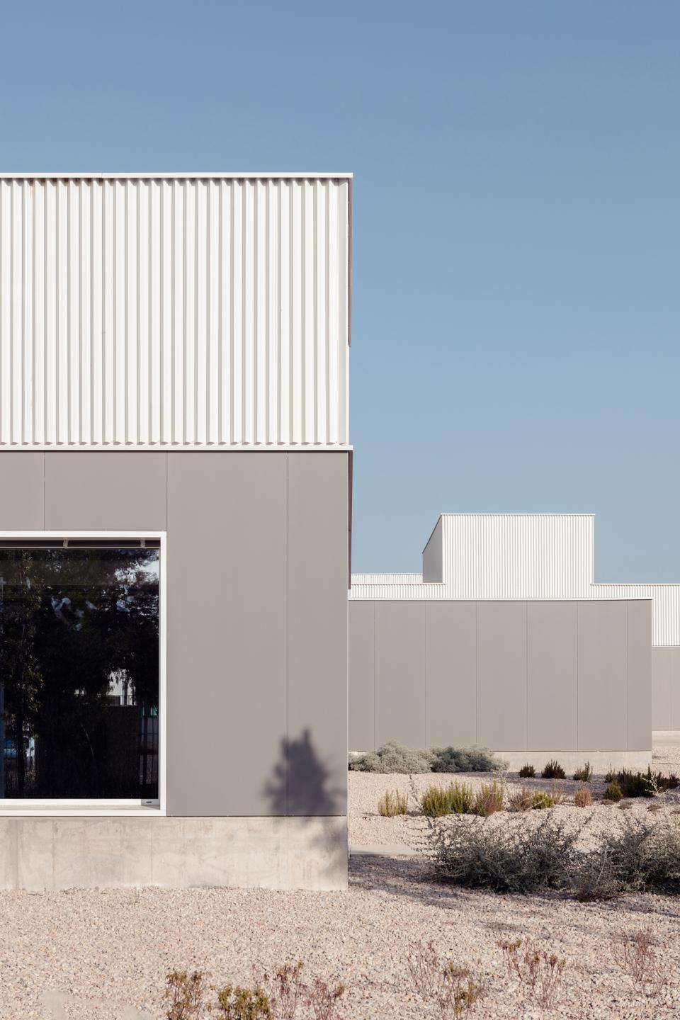 Modern architecture featuring ceramic cladding, showcasing innovative design and creative use of tiles in a landscaped exterior.