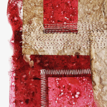 A close-up of layered BioMarble material showcasing vibrant red textures with unique, biodegradable properties.