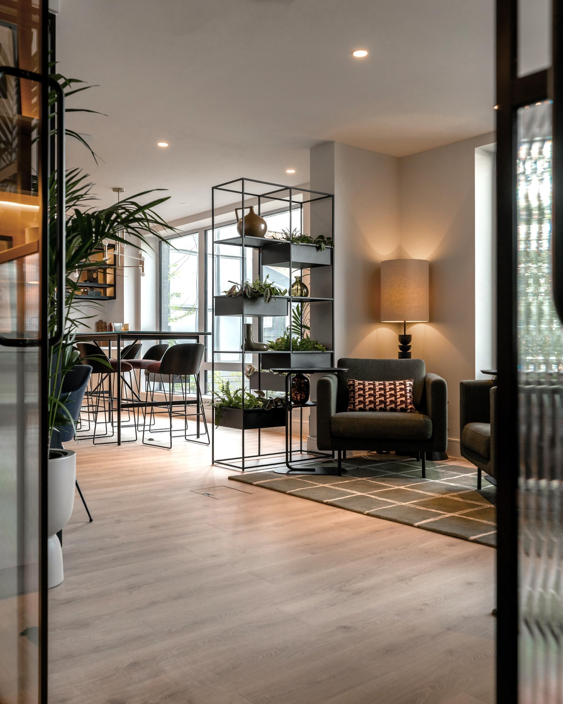 Stylish co-living space featuring modern furniture, plants, and an inviting atmosphere at The Apiary by Ekho Studio.