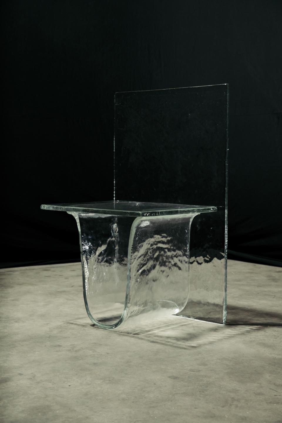Melt collection glass furniture by nendo, featuring a uniquely designed transparent table with flowing curves.
