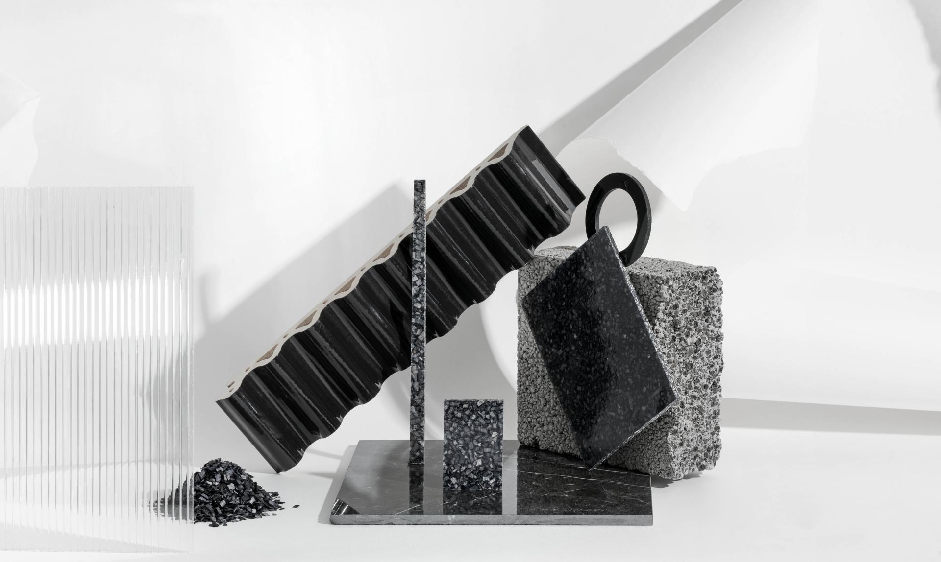 Sustainable black wood composite washroom products displayed artistically, highlighting Woodio's innovative design and low-carbon approach.