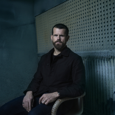 Matthew Day Jackson poses in a modern setting, showcasing the creative collaboration with Made by Choice and Formica Group.