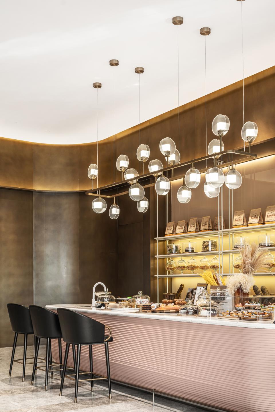 Modern café design featuring a sleek bar, stylish lighting, and an array of pastries, embodying the floating urban metropolis concept.