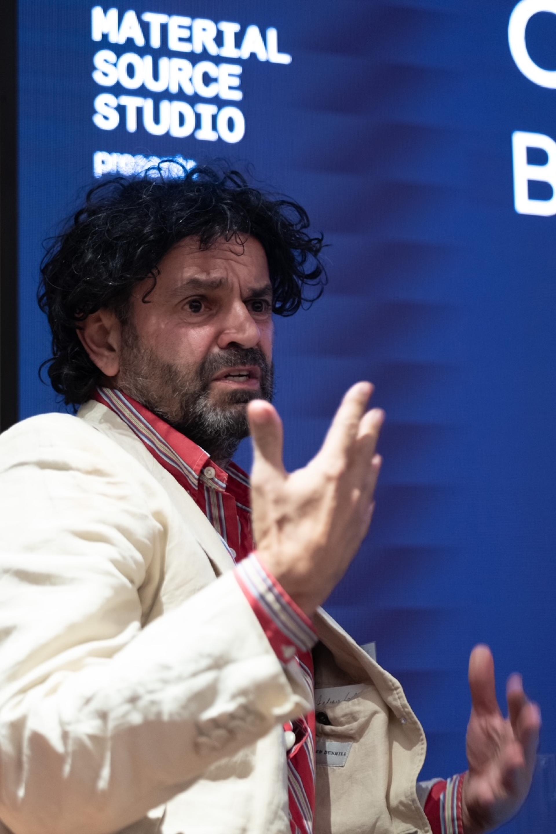 Passionate speaker discussing the future of hospitality and brand experience at Material Source Studio event.