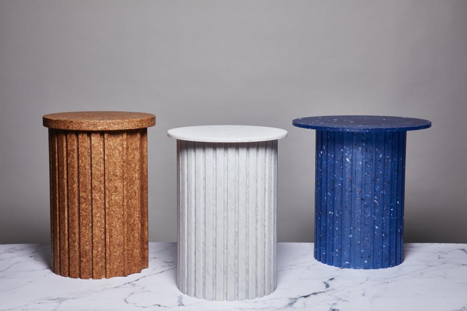Three unique cylindrical tables in earthy, white, and blue materials showcased at London Design Festival 2023.