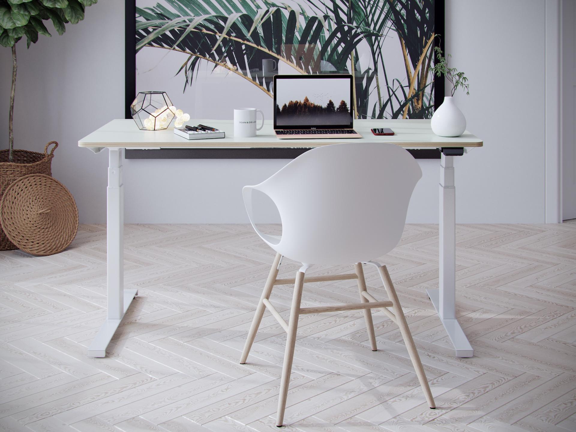 Hi-Lo desk setup featuring a laptop, decorative items, and a modern chair in a stylish workspace.