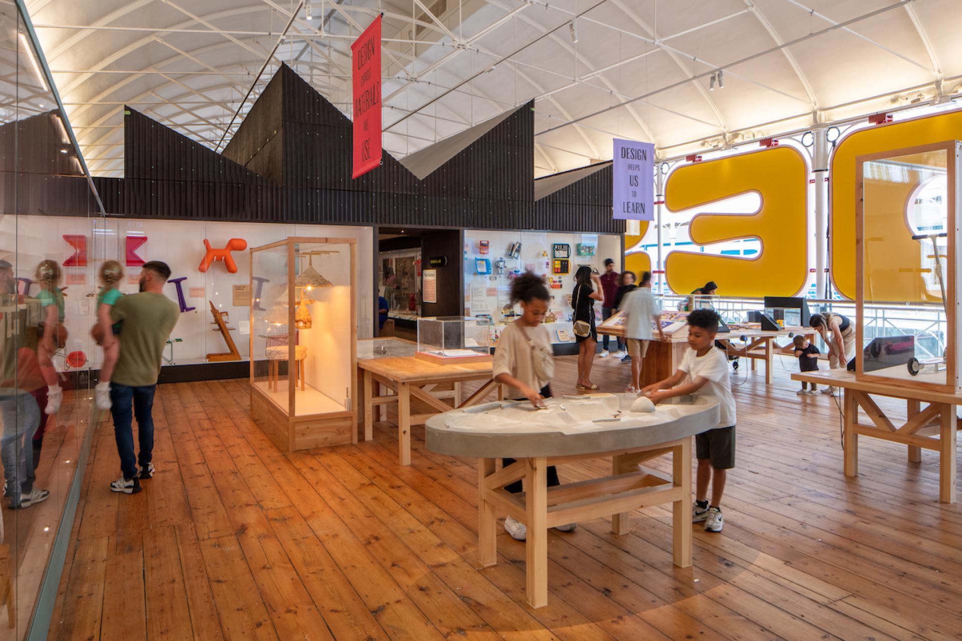 Interactive children exploring playful exhibits inside the Young V&A museum, showcasing design and creativity in a vibrant environment.