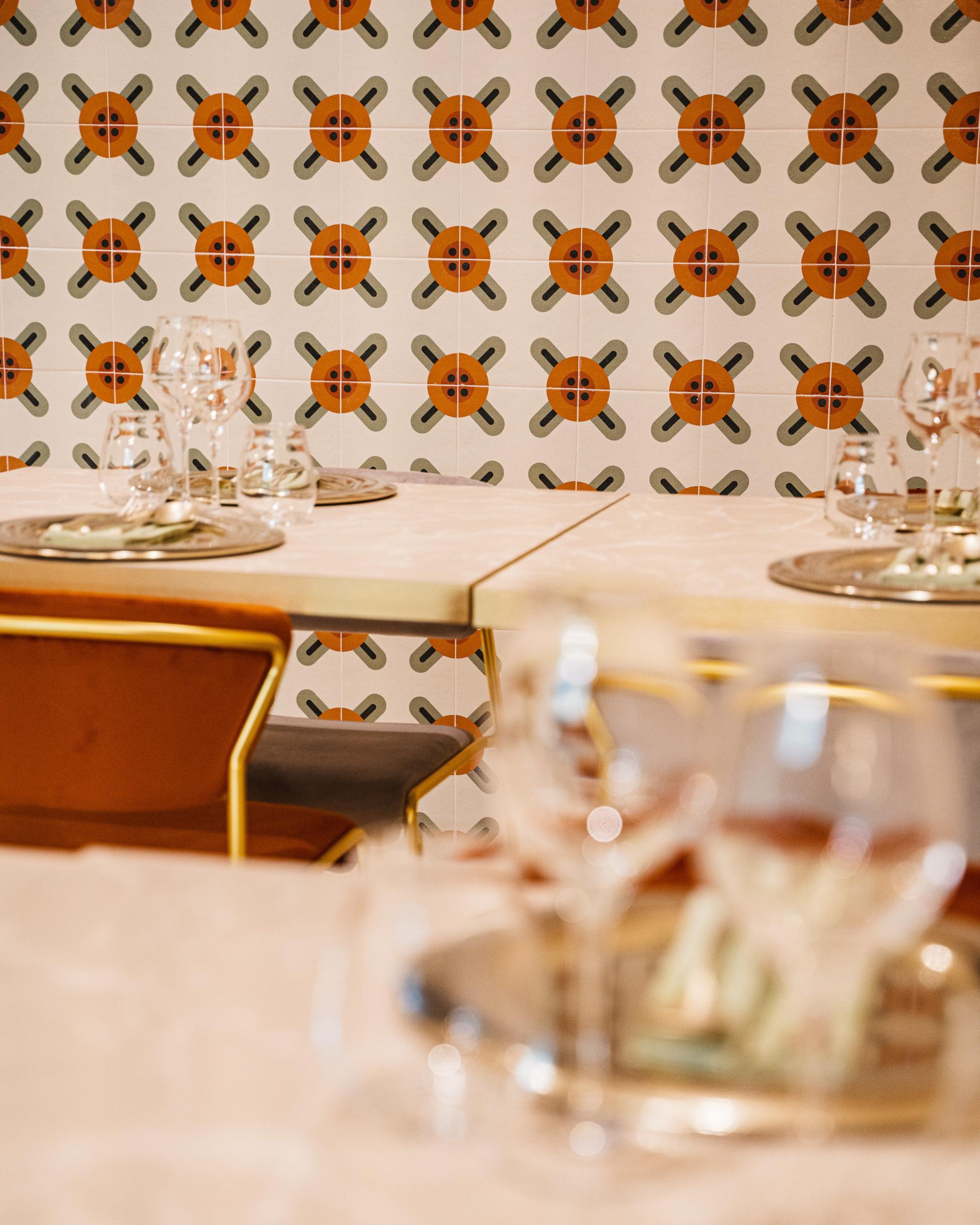 Elegant dining setup featuring S•CAB chairs and vibrant patterned tiles at Linfa Milano restaurant.