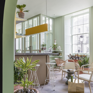 Modern lounge area at Eden Locke, Edinburgh, featuring Smoked Oak flooring, stylish furniture, and vibrant greenery.