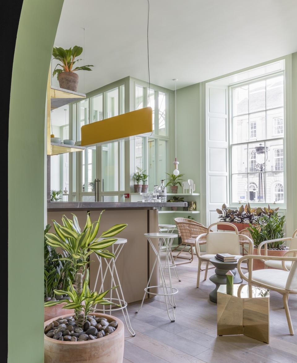 Modern lounge area at Eden Locke, Edinburgh, featuring Smoked Oak flooring, stylish furniture, and vibrant greenery.
