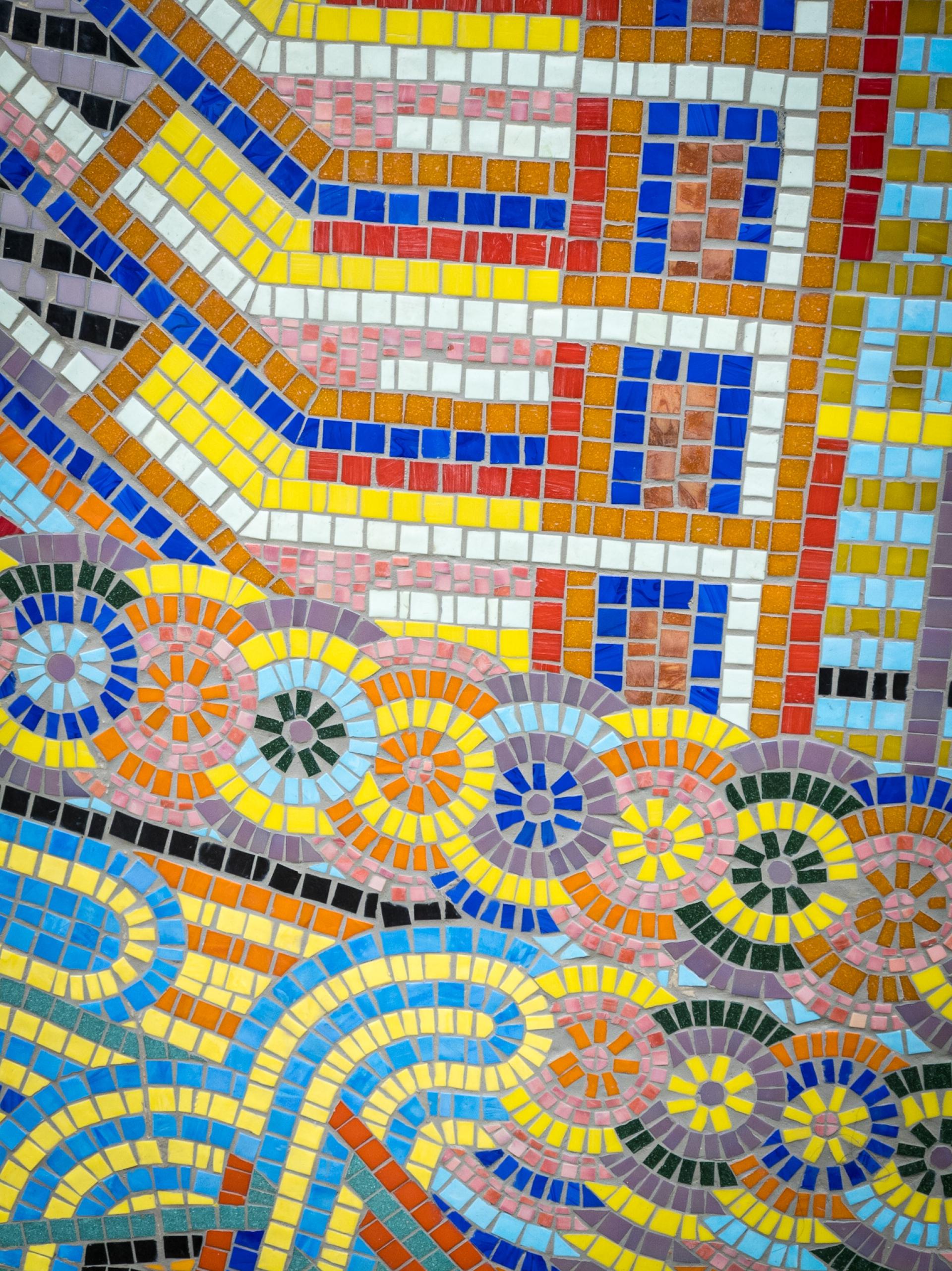 Colorful mosaic design featuring geometric shapes and vibrant patterns, celebrating traditional craft and community diversity.