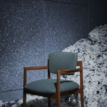 Stylish green tweed chair by Camira, showcasing innovative textile design with pure wool and flax materials.