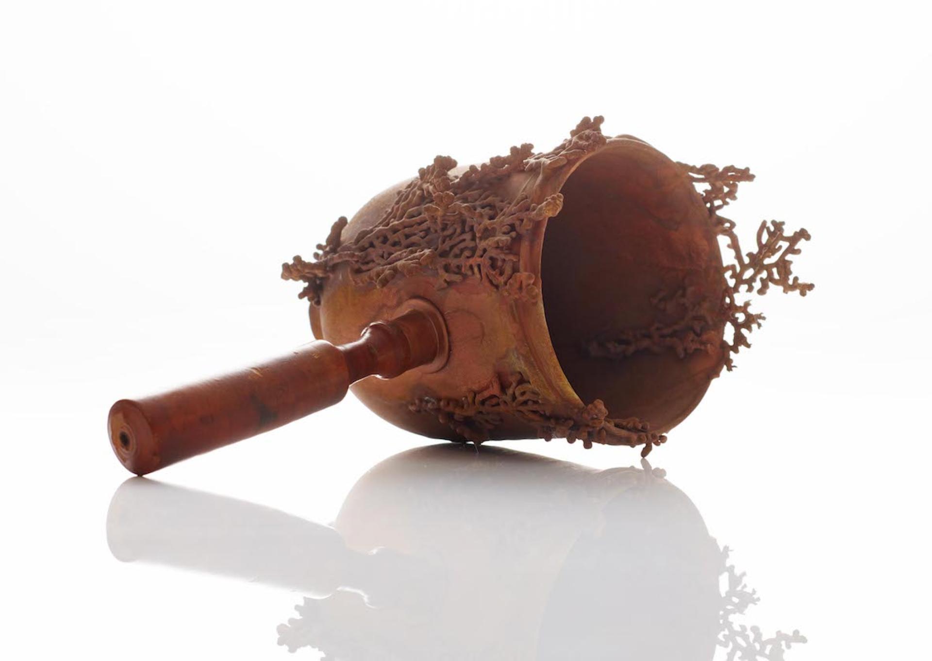 Intricately designed vessel resembling aquatic life, showcasing innovative use of materials in water storage by Katrin Spranger.