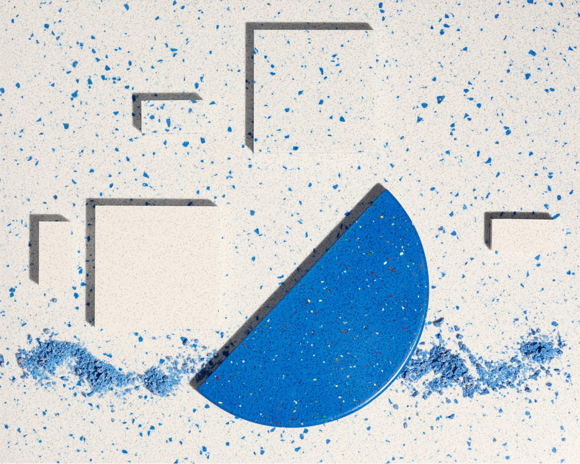 Vibrant blue and white texture featuring circular and rectangular shapes, showcasing Surface Matter's Material Rescue initiative for sustainable design.