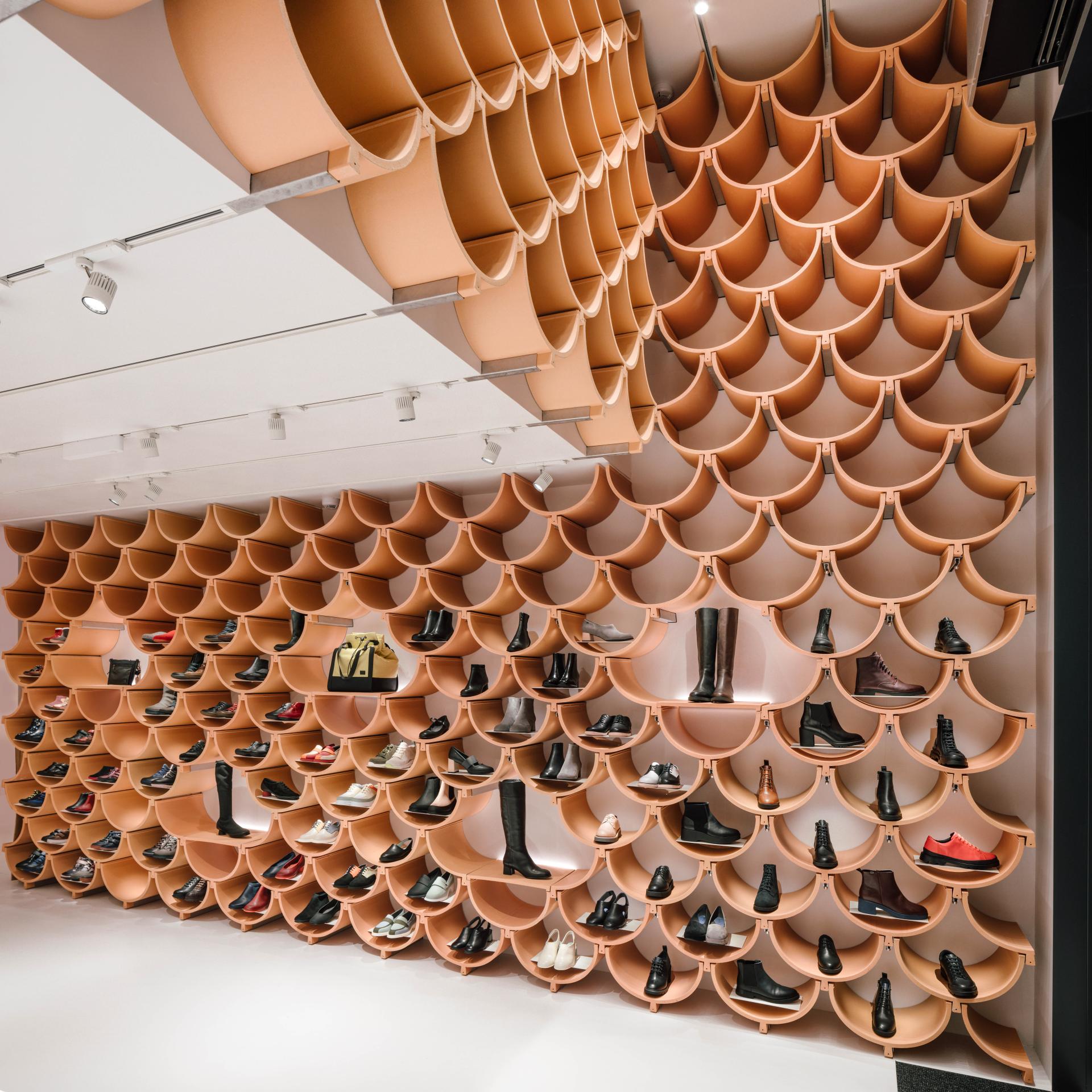 Innovative ceramic wall display showcasing diverse footwear, highlighting imaginative Spanish design in architecture and interior decor.