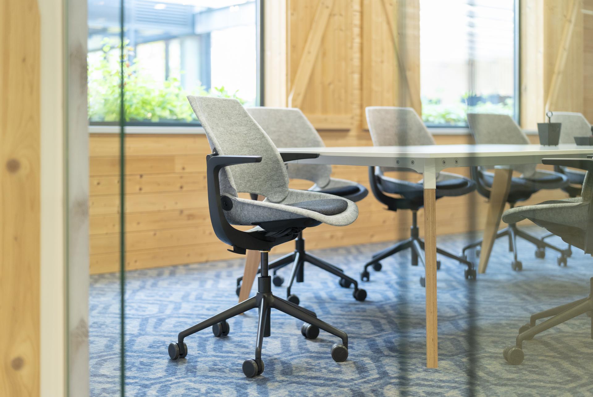 Modern ergonomic office chairs arranged around a sleek conference table in a sustainable workspace at Vepa, Netherlands.