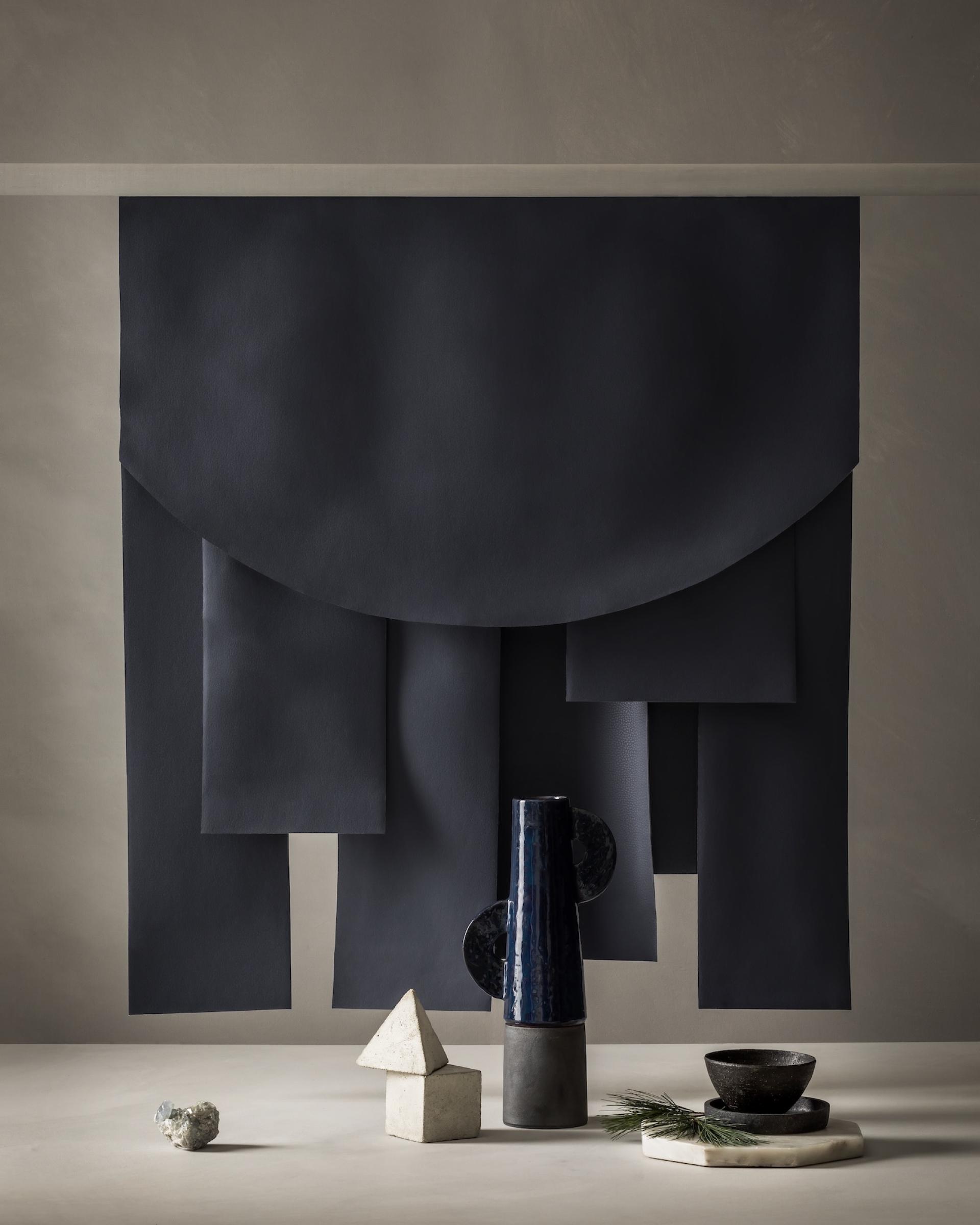 Stylish arrangement of Ultrafabrics' Volar Bio samples in earthy tones, complemented by modern ceramic decor elements.