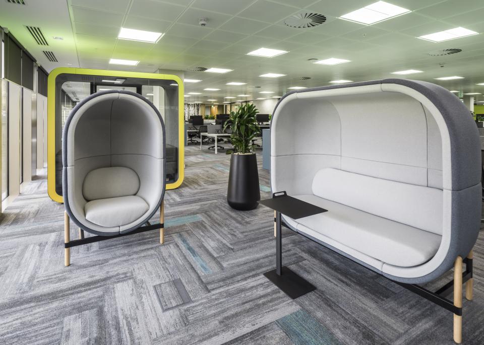 Innovative workspace featuring modern soundproof seating pods for collaborative environments in WELL certified office design.