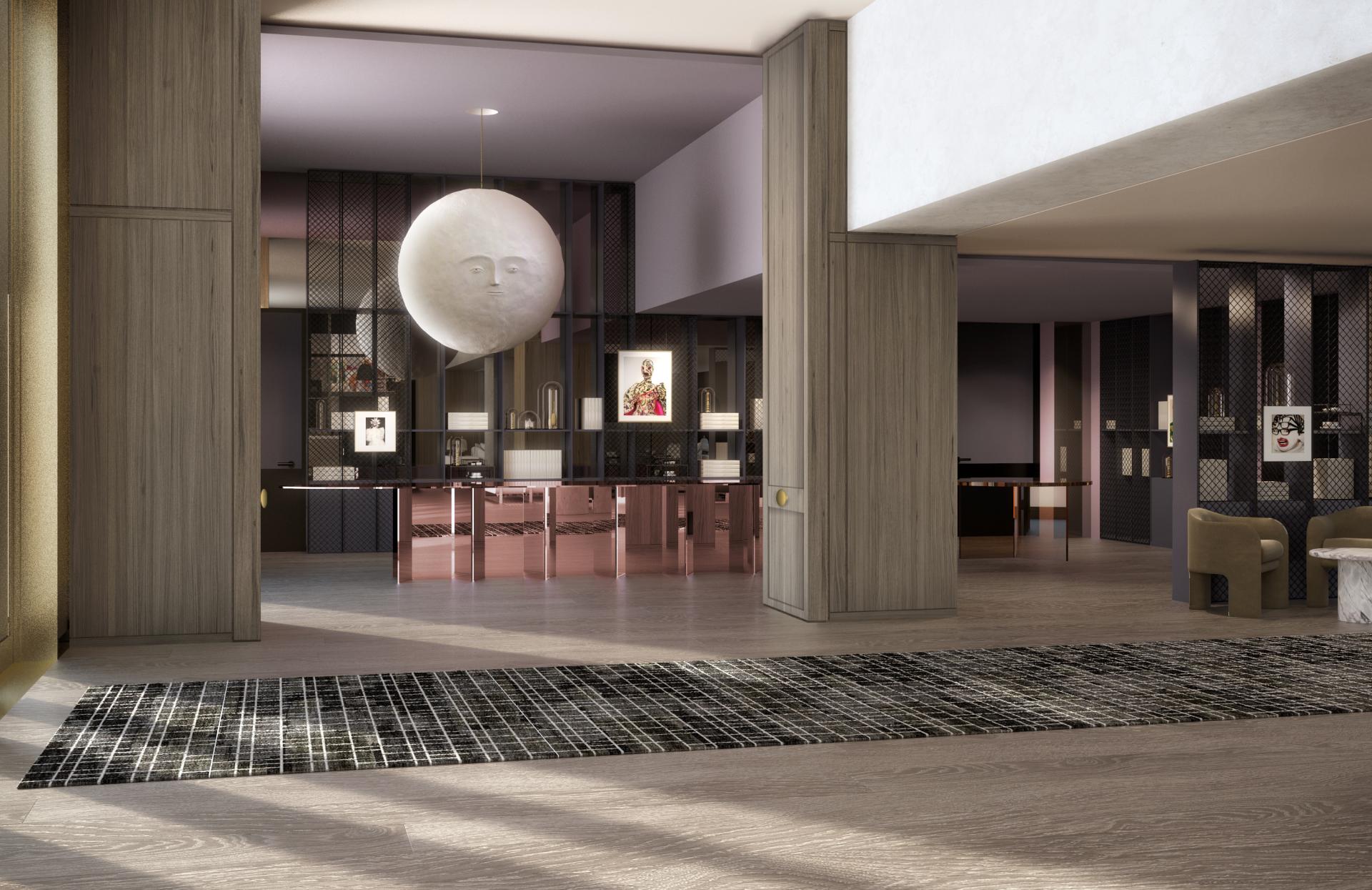 Modern interior design showcasing a spacious entryway with a prominent hanging sculpture and elegant furnishings by Yabu Pushelberg.