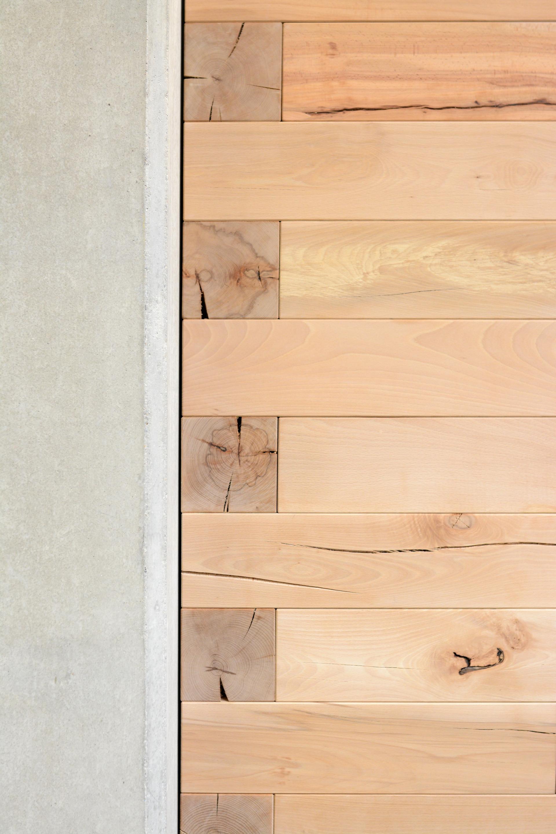 Natural wood planks with distinct grain patterns and textures, showcasing sustainable sourcing and craftsmanship in design.