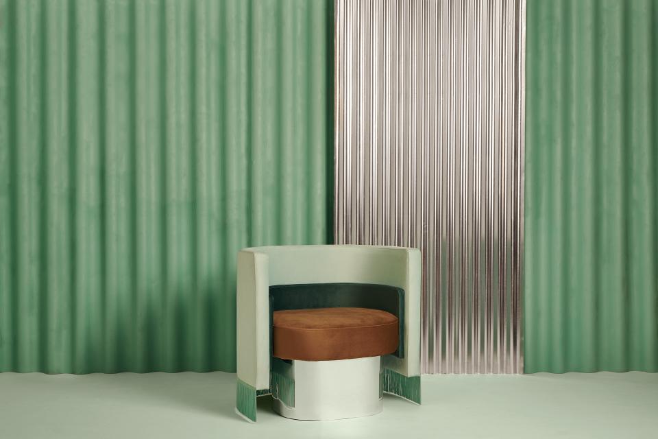 Vintage-inspired chair by Masquespacio, featuring green tones and a brown cushion, set against textured backgrounds.