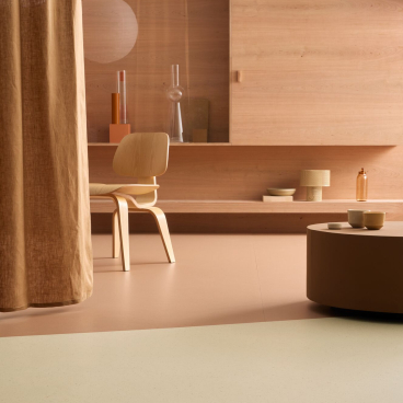 Marmoleum Cocoa flooring in soft shades complements a stylish interior with wooden elements and modern decor accents.