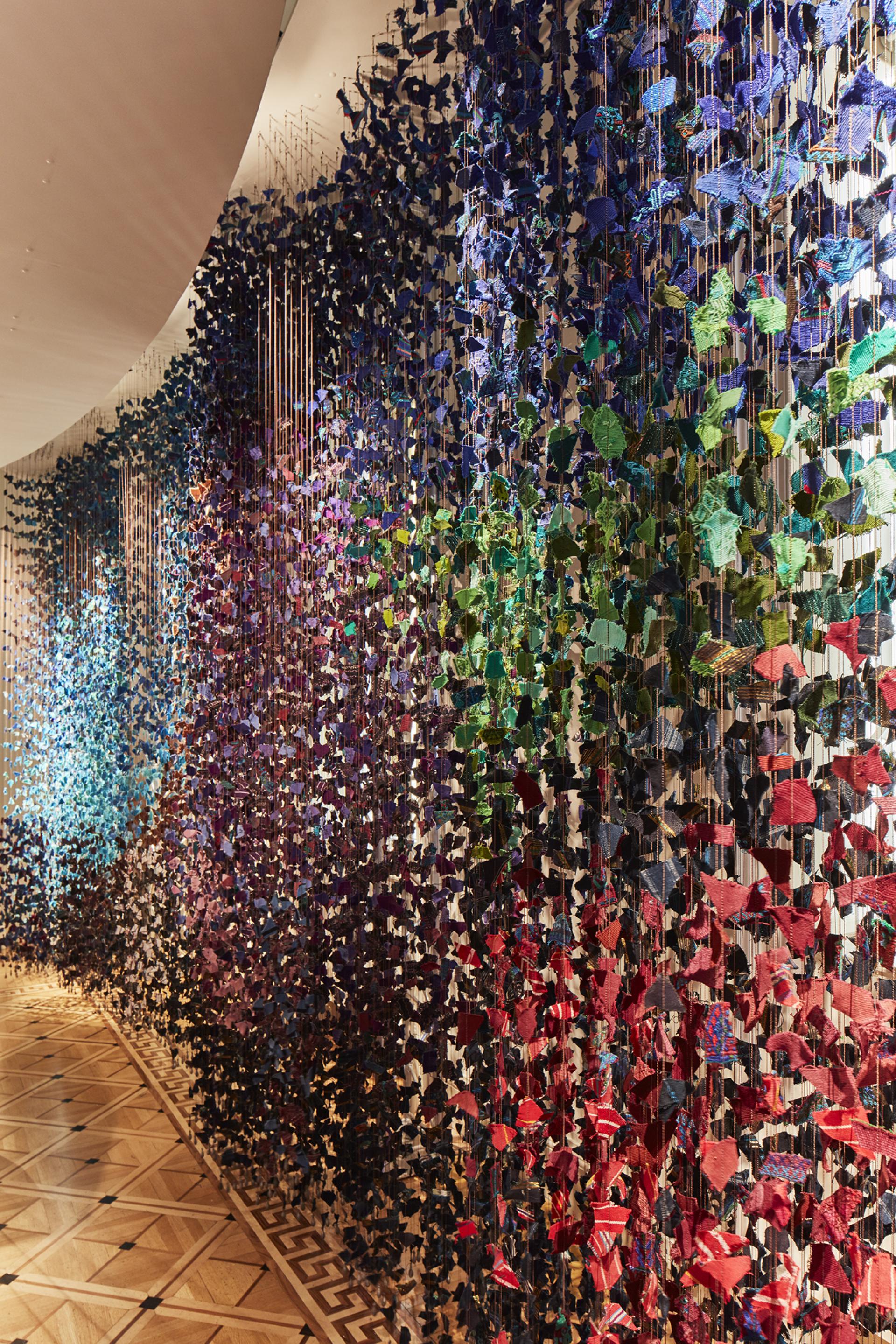 Colorful fabric art installation featuring layered textures and shapes, showcased at the London Design Biennale in Somerset House.