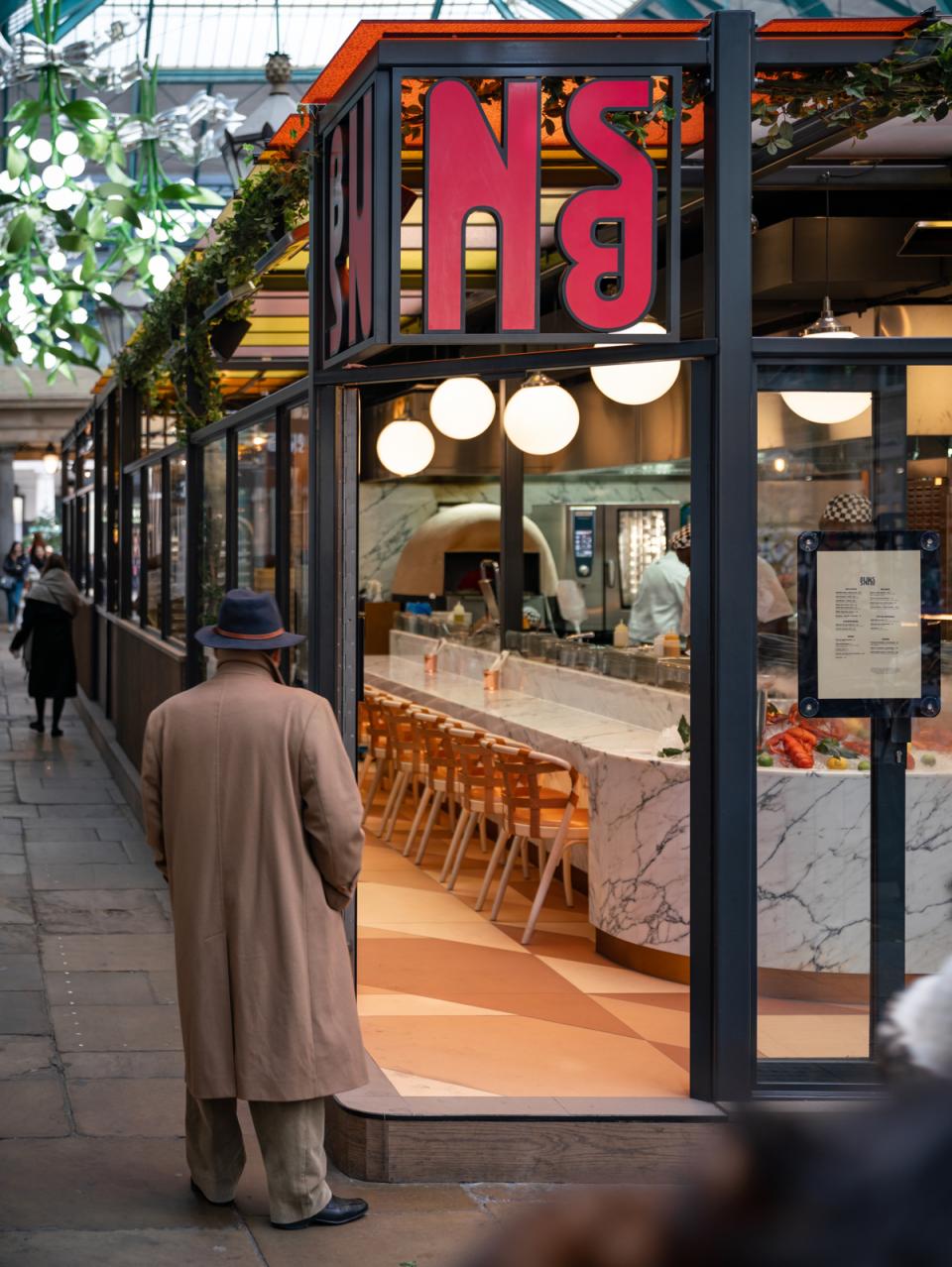 Vibrant entrance of Buns & Buns restaurant in Covent Garden, featuring modern decor and inviting atmosphere.