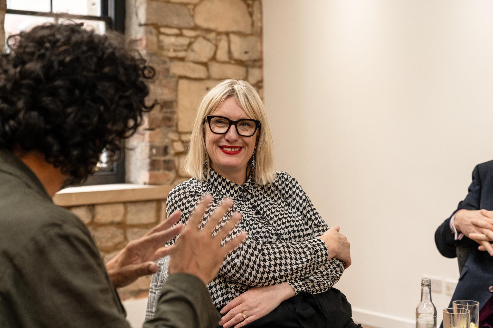 Participants engaging in discussion at the Glasgow Property Outlook seminar, showcasing collaboration in property development insights.
